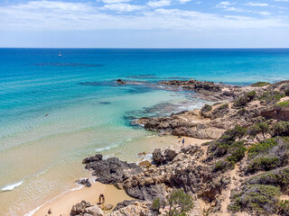 Crystal clear and tropical sea at Del Morto beach, view from flying drone Chia Beach