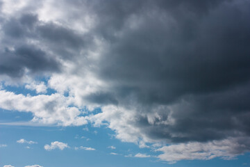Obraz premium dark and white clouds on blue sky, selective focus