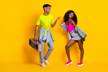 Full length body size view of handsome beautiful cheerful couple dancing having fun pastime isolated on bright yellow color background