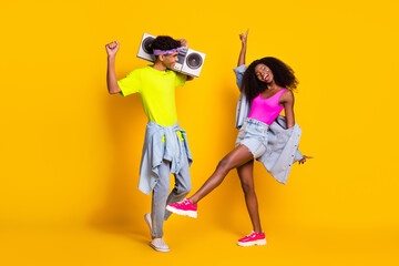 Full length body size view of handsome beautiful cheery dreamy couple dancing chill out isolated over bright yellow color background