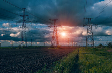  high-voltage  power lines at storm clouds.