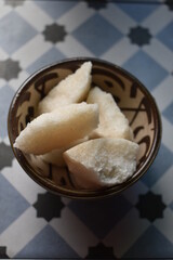 Large piece of sugar loaf for tea on ethnic bowl