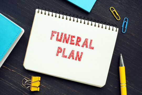 Financial concept about FUNERAL PLAN with sign on the piece of paper. A Funeral Plan is an easy way to pre-arrange the funeral you want and pay for the funeral director's services at today's prices