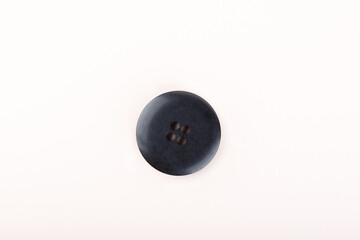 Top view of an old black plastic button.