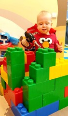 a child plays with a toy constructor
