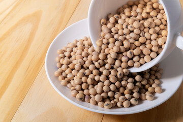 Organic soy beans on wooden table, flat lay.