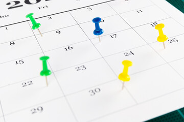 Thumbtack in calendar for busy, appointment and meeting reminder.