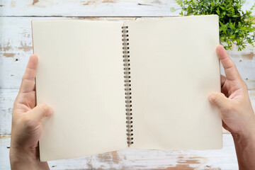 Obraz premium Two men's hands holding a blank book