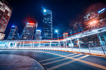 modern buildings in modern city from elevated road at night