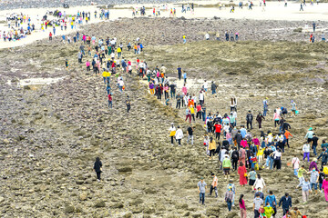 Pilgrims walk across island to temple to worship goddess for peace their families on full moon day of first lunar month in Vung Tau, Vietnam.