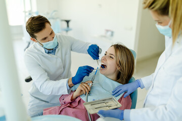 Woman having teeth examined at dentists.