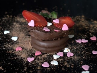 Cookies with chocolate cream and strawberries decorated with sugar and cinnamon hearts