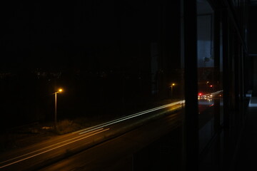 Night photo with long exposure with street lamp and cars front and rear lamps reaminings on the photo.