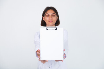 Female doctor in lab coat on white background isolated, confident smile hold white paper blank with empty space