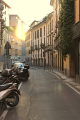 Fototapeta na wymiar Sunset in a street in Milan, Italy