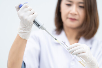 A young woman researcher, doctor, scientist, or laboratory assistant working with plastic medical...