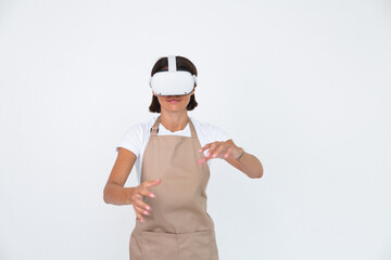 Housewife in apron isolated on white background in vr glasses cooking making dinner play games