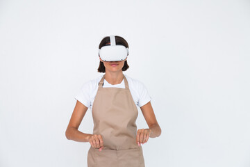 Housewife in apron isolated on white background in vr glasses cooking making dinner play games
