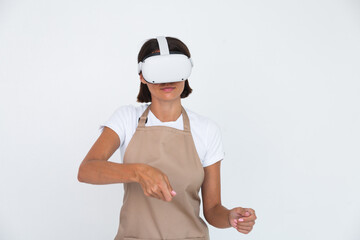 Housewife in apron isolated on white background in vr glasses cooking making dinner play games