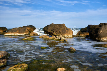 Fototapeta na wymiar Seascape with rocky coast in summer on a sunny day