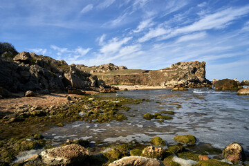 Fototapeta na wymiar Seascape with rocky coast in summer on a sunny day