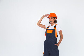 Pretty woman engineer in building protective helmet on white background confident smile look far away