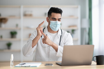 Arab doctor in face mask having video chat with patient