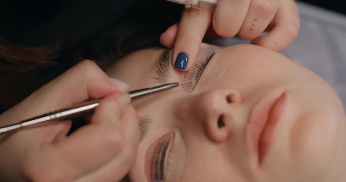Lashmaker does the eyelash lamination procedure for the client in the beauty salon, cosmetic services, beauty care procedures, 4k 60p Prores HQ