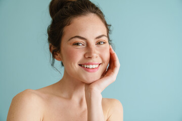 Half-naked brunette woman smiling and looking at camera