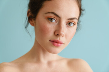 Half-naked brunette woman posing and looking at camera