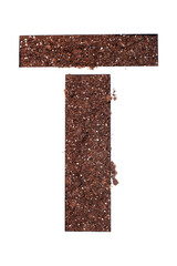 stencil letter T made above dirt on white surface
