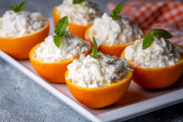 Celery salad with apple and walnuts served in orange cups.