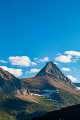 Fototapeta premium partially snow covered jagged mountain peaks of Glacier National park near Iceberg Lake trail during summer.