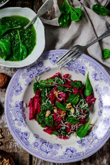 Beet pasta with spinach pesto .style rustic