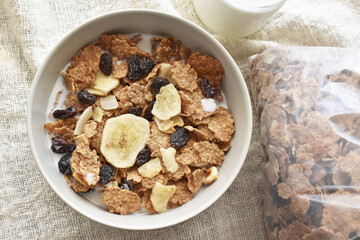 Fruit and fiber cereal with milk in a bowl.  The concept of healthy breakfast, healthy food, dietary plan and weight loss program.