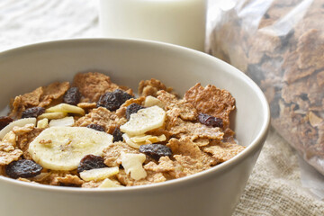 Fruit and fiber cereal with milk in a bowl.  The concept of healthy breakfast, healthy food, dietary plan and weight loss program.