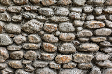 The basement wall is lined with stone blocks of various shapes and sizes. As a natural background.