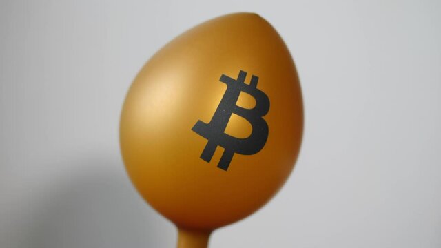 Bitcoin balloon inflating with air.
