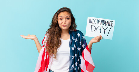young pretty woman feeling puzzled and confused and doubting independence day concept