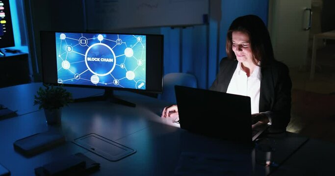 Business woman working at night inside bank company office doing blockchain research - Trading, investment and financial concept 