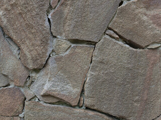 Close-up of dark colored natural stone wall