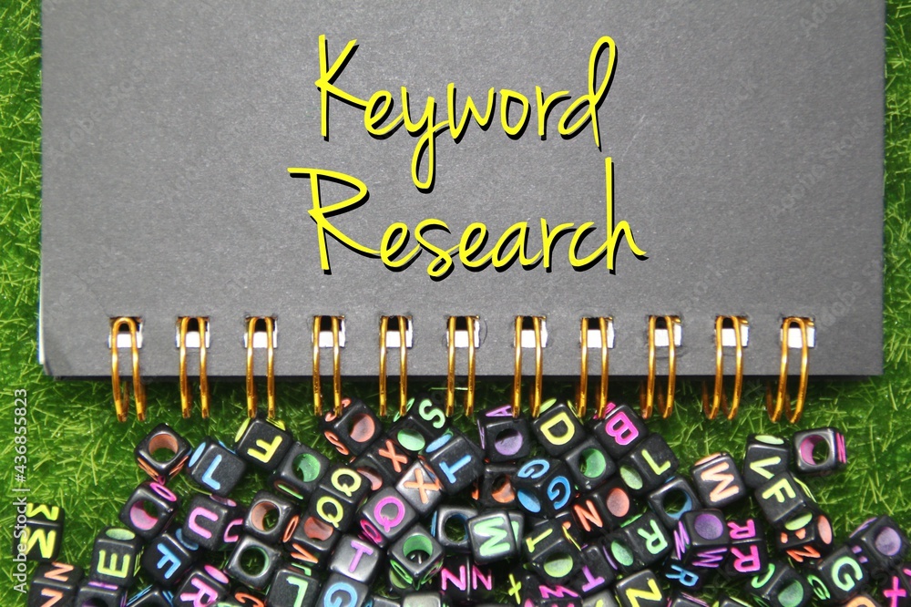 Poster notebooks and lowercase letters of the abc alphabet strewn with word research keywords