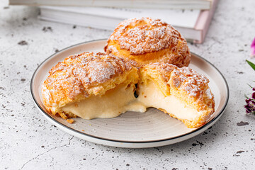 Fresh baked choux pastry cakes with cream filling