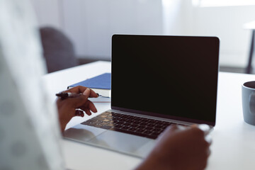 African american woman using laptop with copy space on screen