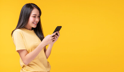 Cheerful asian woman holding smartphone and her hand with shocked amazed for success or get good...