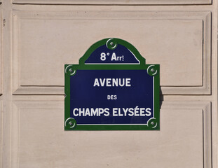 A sign with the name of the street on the wall of the house. The inscription is in French. Champs...