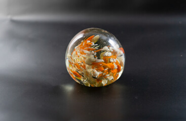 Closeup of a multicolor glass paperweight on a dark background