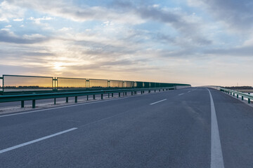 road bridge surface with sunrise sky