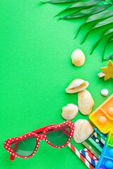 summer background mood, tropical leaf, sun glasses, seashells, accessories travel vacation, ocean sea summer toy positive mood top view