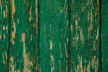Background wooden board with cracked paint. Color-Peel wood texture. Blackboard in old peeling paint. Copy space. Space for text.